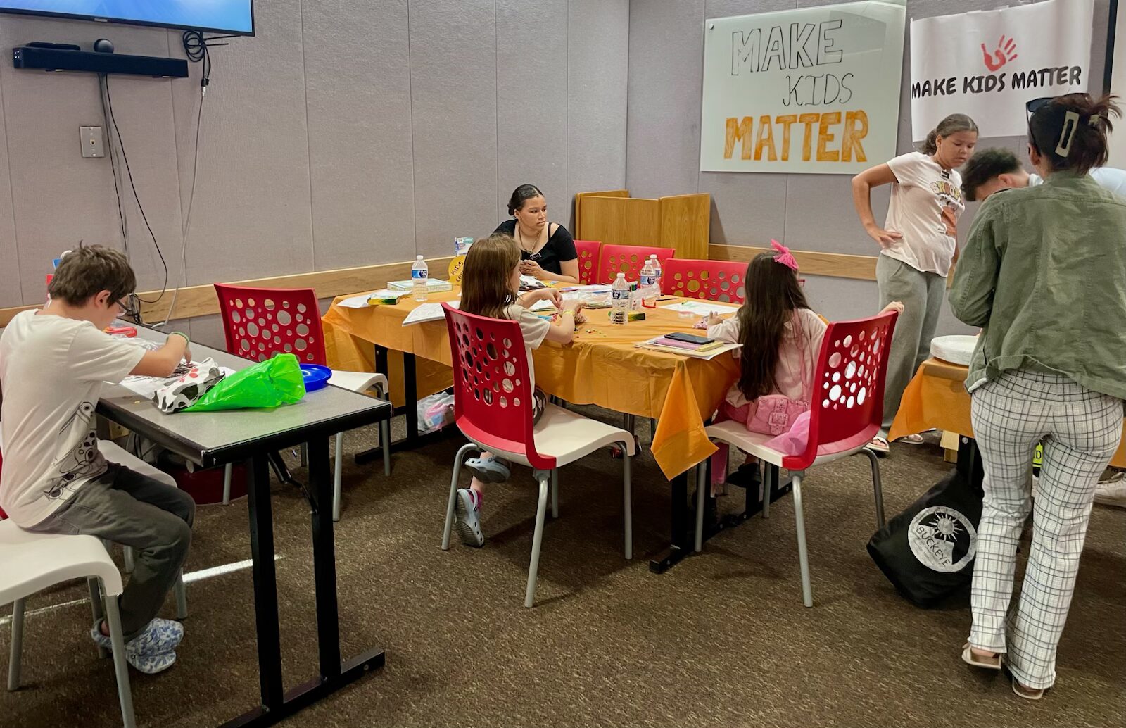 Volunteers and children at a Make Kids Matter community event